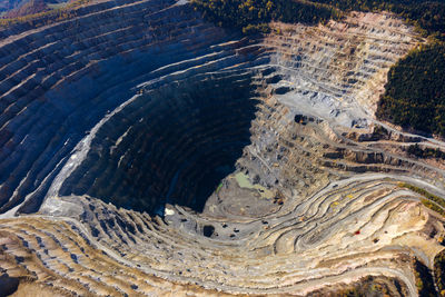 Aerial drone view of europe second largest open pit copper mine, rosia poieni, romania