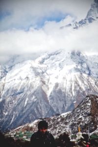 Tourists on snow covered mountain