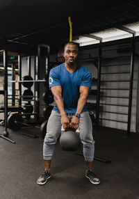 Full length of man exercising in gym