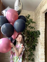 Young woman holding balloons