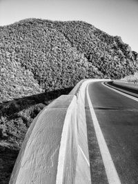 Road leading towards mountain against sky