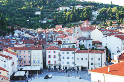 Red roofs of old town piran with main church against the sunrise sky, adriatic sea. slovenia