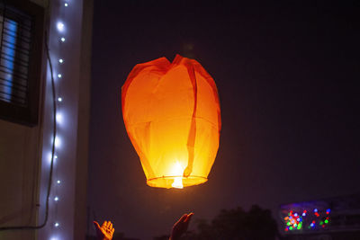 Low angle view of illuminated lanterns at night