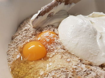 High angle view of baking ingredients and egg in a bowl 