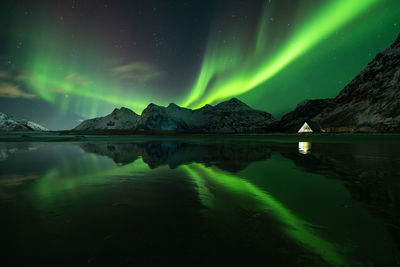 Scenic view of lake against sky at night aurora borealis reflection