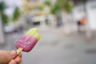 Close-up of hand holding ice cream cone