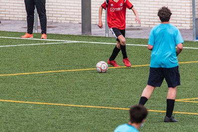 Low section of man playing soccer