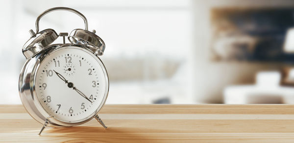 Close-up of clock on table at home