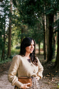 Young woman standing in forest
