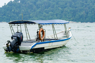 Boat in swimming pool against lake