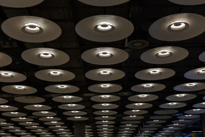 Low angle view of illuminated pendant lights hanging from ceiling