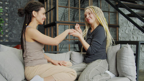 Smiling young woman sitting at home