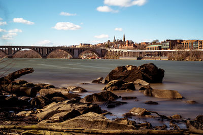 Bridge over river with city in background