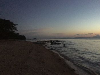 Scenic view of sea against clear sky at sunset