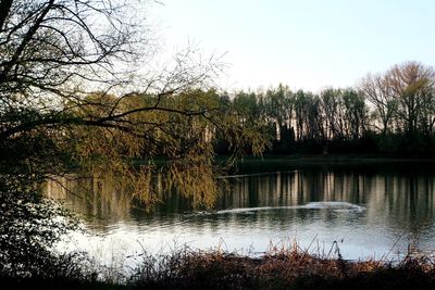 Scenic view of lake against sky at sunset