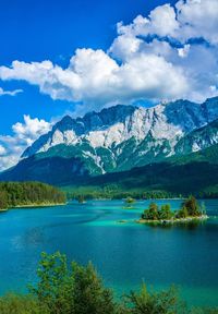 Scenic view of lake and mountains against sky