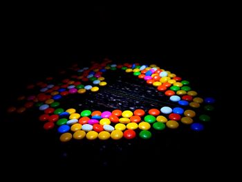 Close-up of colorful balloons over black background