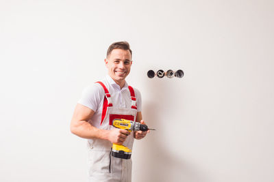 Portrait of a smiling young man against white background