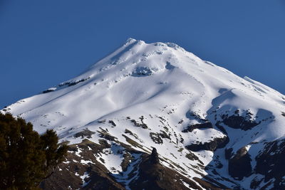 Scenic view of snowcapped mountains against clear blue sky