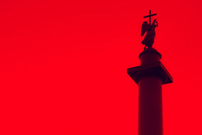 Low angle view of statue of red bell tower