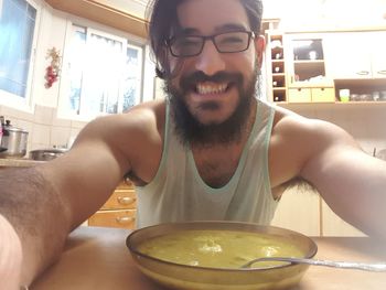 Portrait of man drinking glasses on table