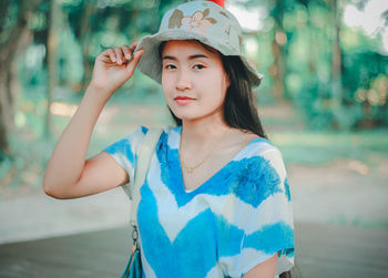 Portrait of young woman wearing hat