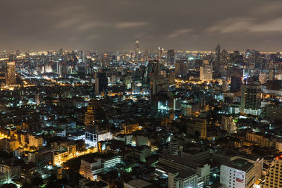 Illuminated cityscape against sky at night