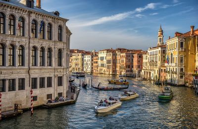 Boats in canal along buildings