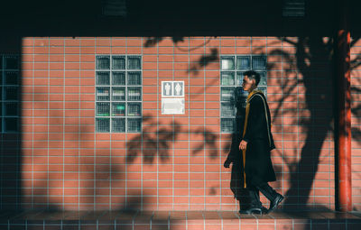 Man and woman walking on wall