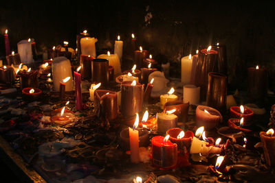 Close-up of illuminated candles in temple