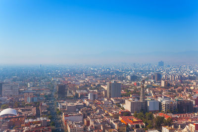 High angle view of buildings against blue sky