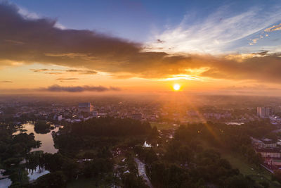 Aerial view of city against sky during sunset