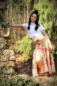 Portrait of woman standing in forest