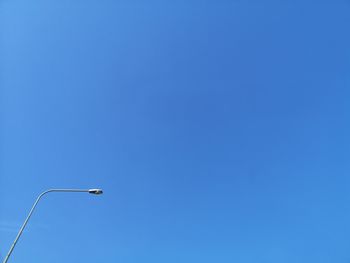 Low angle view of street light against clear blue sky