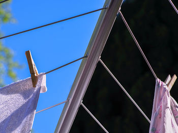 Low angle view of ropes hanging on rope against sky