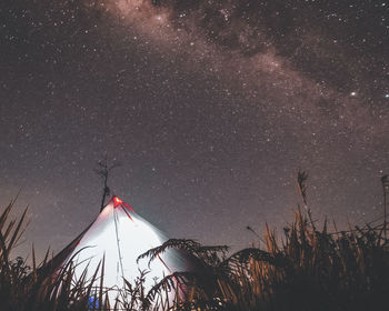 Low angle view of tent against sky at night