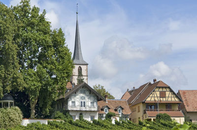 Panoramic view of trees and buildings against sky