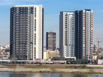 Modern buildings against sky in city