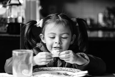 Portrait of cute girl sitting on table
