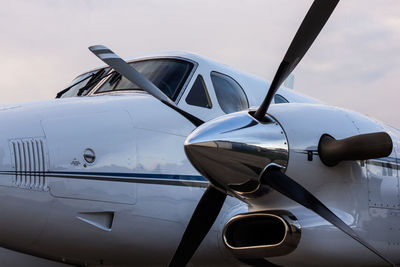 Airplane on airport runway against sky