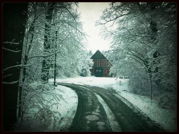 Road passing through snow covered landscape