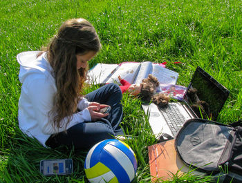 High angle view of woman sitting on grass