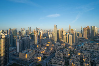 Aerial view of modern buildings in city against sky