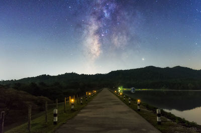 Scenic view of illuminated mountains against sky at night