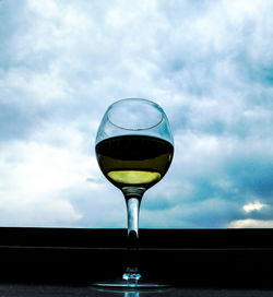 Close-up of beer in water against sky