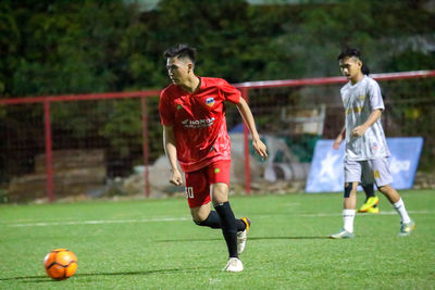 Men playing soccer on field