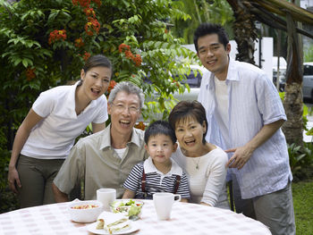 Portrait of happy family at back yard