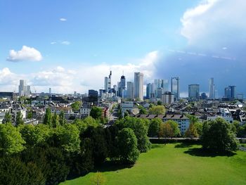 View of cityscape against cloudy sky