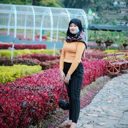 Portrait of a smiling young woman standing outdoors