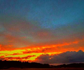 Silhouette of mountain against dramatic sky